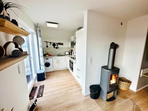a kitchen with a wood stove in a room at Räuberhöhle by Seeblick ferien oro in Kappeln