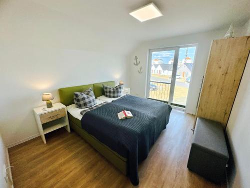 a bedroom with a bed with a book on it at Räuberhöhle by Seeblick ferien oro in Kappeln