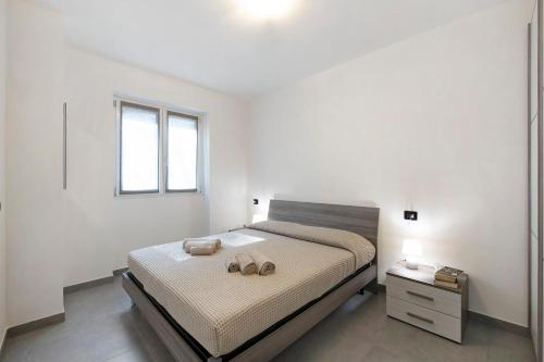 a bedroom with a bed with two shoes on it at Appartamento 5 Il Tornante in Nesso