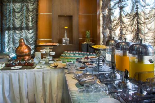 a buffet with food and drinks on a table at Diyafat Al Saada Serviced Apartments - Ishbillia in Riyadh