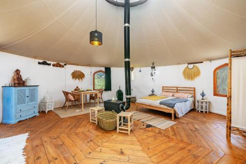 a bedroom in a tent with a bed and a table at Eco Yurta Lanjarón in Lanjarón
