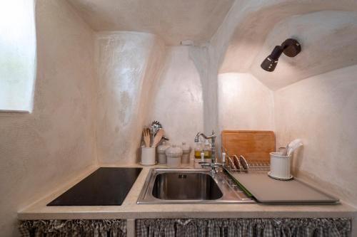 a kitchen with a sink and a counter top at Suite Cavour 30 in Ostuni