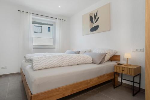 a bedroom with a large bed with a window at Herzensprojekt in Pfullendorf