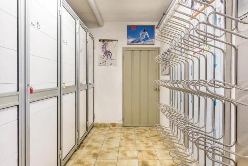 a hallway with a row of racks in a room at Kamerloy Apartments B in Campitello di Fassa