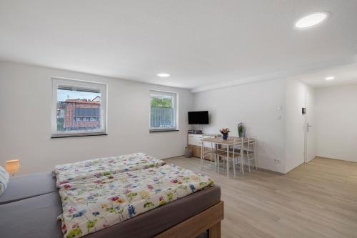 a bedroom with a bed and a table in it at Casa Karlsplatz in Freiamt