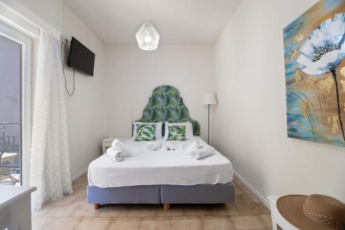 a bedroom with a bed with a blue headboard at M4 room in Nikiana