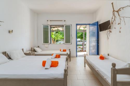 two beds in a room with white walls at Perasma Studios 10 in Kipri