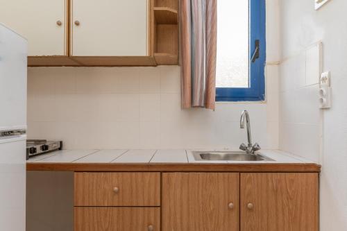 a small kitchen with a sink and a window at Perasma Studios 10 in Kipri