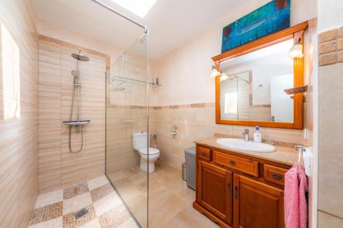 a bathroom with a shower and a sink and a toilet at Can Juanito in Alcudia