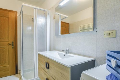 a bathroom with a white sink and a mirror at Villetta Crepaz in Canazei