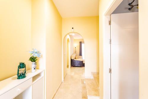 a hallway leading to a bathroom with a mirror at Vista Hermosa in Ayamonte