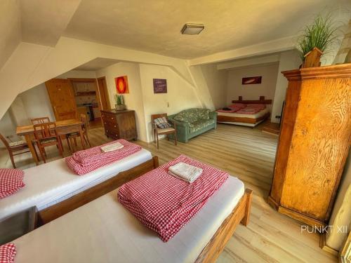 a room with two beds and a living room at Wohnung 3 in Burghaslach