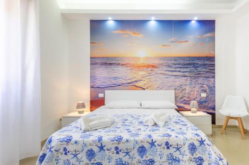 a bedroom with a bed with a view of the ocean at Villa Lindarelax in Santa Maria del Focallo