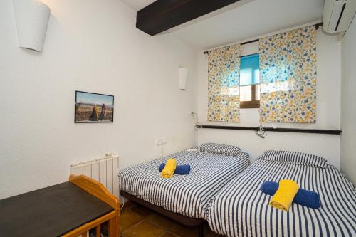 two twin beds in a room with white walls at Casa Colina in Albir