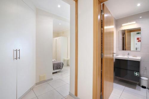 a bathroom with a sink and a mirror at Bay View Albufeira in Albufeira