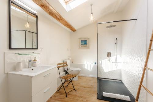 a bathroom with a shower and a sink and a toilet at La Belle Parenthèse à la Rochelle in Vergné