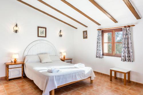 a bedroom with a bed and a window at Es Figueral in Campos