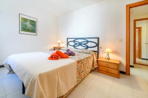 a bedroom with a bed and a night stand with a lamp at Puerto Rico Apt. Port de Sóller in Port de Soller