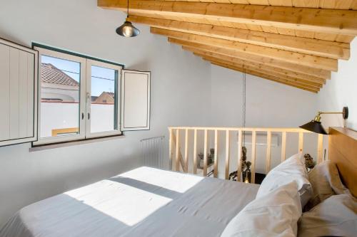 a bedroom with a bed and two windows at Casa Valada My Land in Valada