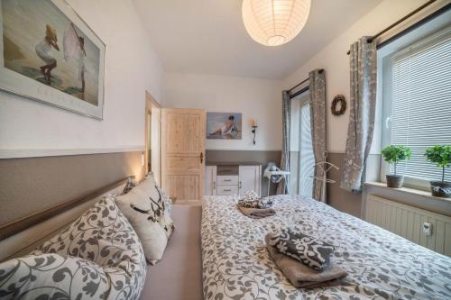 a bedroom with a bed and two pillows at Harzperle Wohnung Nr 6 in Braunlage