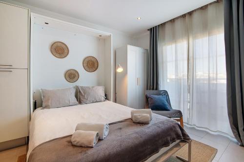 a bedroom with a large bed and a chair at Bay View Albufeira in Albufeira