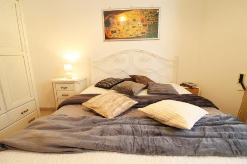 a bed with pillows on it in a bedroom at Casa Caterina a Otranto in Otranto