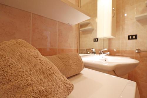 a bathroom with a sink and a toilet and a mirror at Casa Caterina a Otranto in Otranto