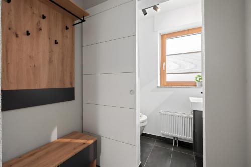 a bathroom with a toilet and a window at Rosenquarz in Überlingen