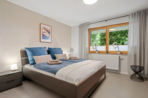 a bedroom with a large bed and a window at Rosenquarz in Überlingen