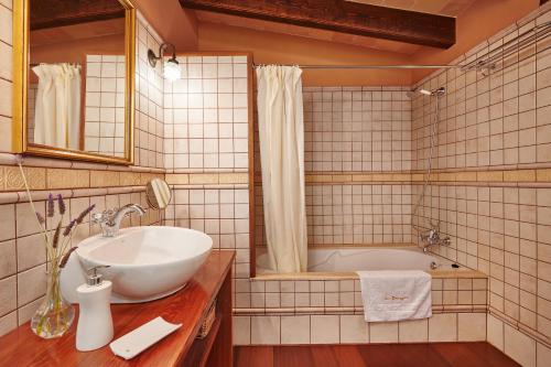 a bathroom with a sink and a tub at Son Soler - Can Torres in Islas Baleares