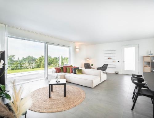 a living room with a white couch and a table at Villa Angelina in Lazise