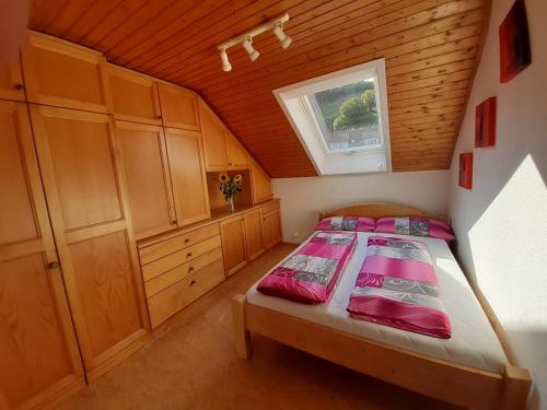 a bedroom with a bed in a wooden room at Ferienwohnung am Geißberg in Kleines Wiesental