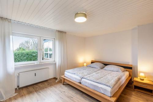 a bedroom with a bed and a window at Haus im Igelweg in Bad Münstereifel