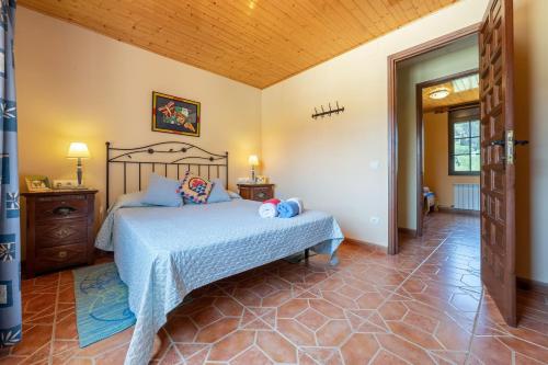 a bedroom with a bed and a wooden ceiling at Casa Pont in Tarragona