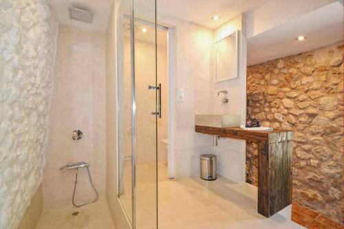 a bathroom with a shower with a glass door at Sestadors in La Puebla