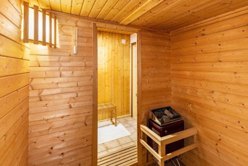 a wooden cabin with a sauna with a window at La Casa Holzwiesen in Starzach