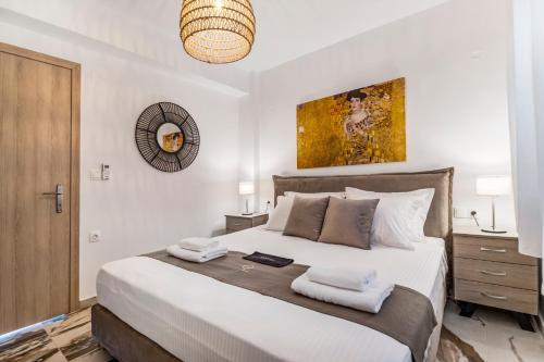 a bedroom with a large bed with two towels at Oceanida Thalia Lyxury Suite in Nikiana