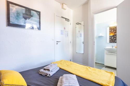 a room with a bed and a sink and a mirror at Chambres Espace Rennaissance in Chantonnay