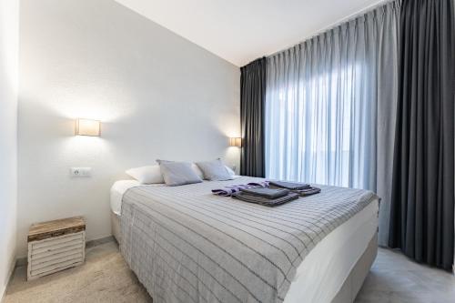 a bedroom with a large bed and a window at Casa Feliz in Mijas