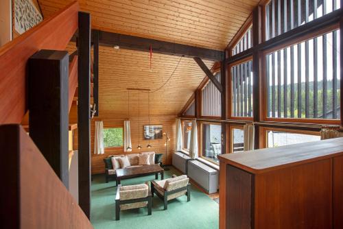 a living room with a couch and some windows at Haus 7 Bernau in Bernau im Schwarzwald