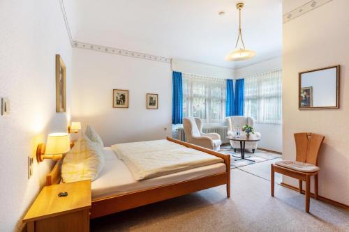 a bedroom with a bed and a living room at Pension Alte Gerbe in Außerurberg