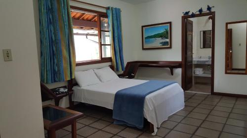 A bed or beds in a room at Pousada Agua Viva