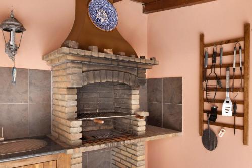 a stone oven in a kitchen with a wall at Villa Ramos in Lagos