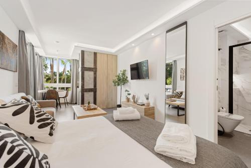 a white living room with a large bed and a living room at Manuela's whim in Málaga