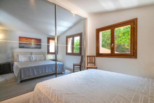 a bedroom with a bed and a window at Villa Sirius - sea view - wellness in Costa Paradiso