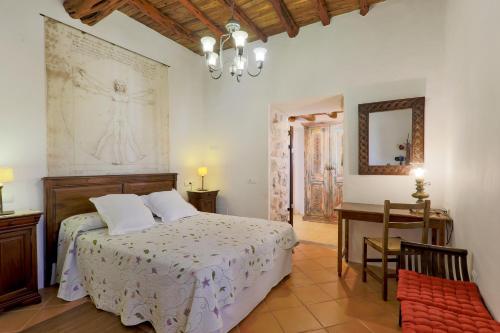a bedroom with a bed and a table and a desk at Can Caseres in Santa Eularia des Riu