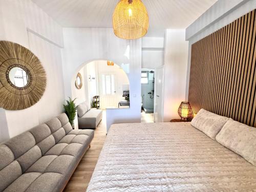 a living room with a large bed and a couch at aeolian blu 6 in Parikia