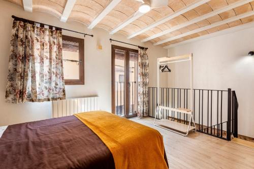a bedroom with a bed and a window at Entre Eras Aptos Rurales La Bodega in Ademuz