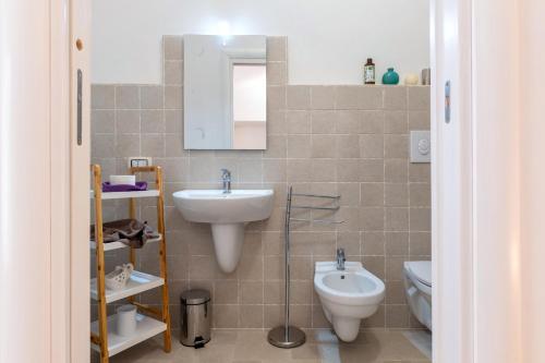 a bathroom with a sink and a toilet at Arco Antelmy in Ceglie Messapica