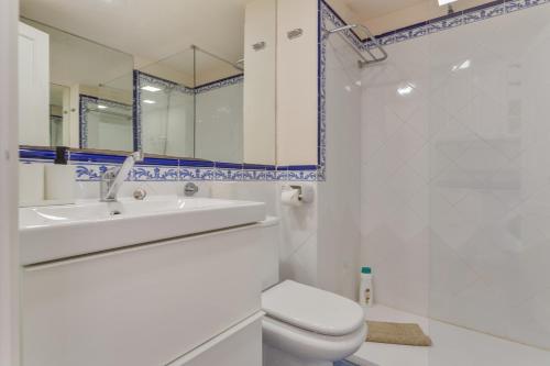 a bathroom with a toilet and a sink and a mirror at Oasis Duna_ Casa Elena Pool in Corralejo